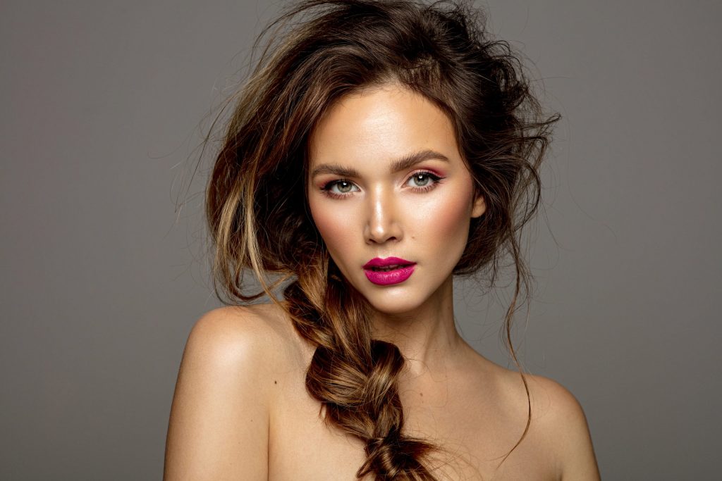 Beauty portrait of female model with messy hair and braid